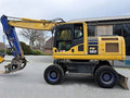 Pelle Komatsu PW180-10 + OilQuick OQ70-55