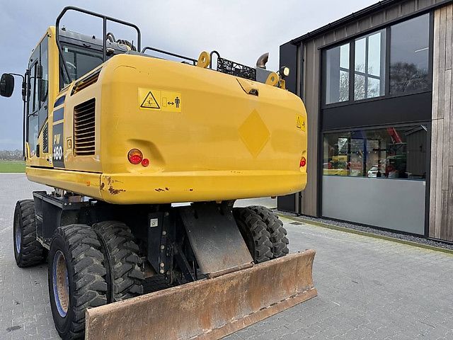 Pelle Komatsu PW180-10 + OilQuick OQ70-55